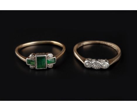 AN EMERALD AND DIAMOND PANEL RING, the rectangular step-cut emeralds and single-cut diamonds in collet settings, two colour p