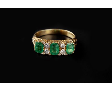 AN EMERALD AND DIAMOND HALF HOOP RING, the rectangular step-cut emeralds spaced by pairs of round brilliant and Swiss-cut dia