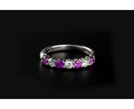 A RUBY AND DIAMOND HALF HOOP RING BY TIFFANY &amp; CO, alternately claw set with circular mixed-cut rubies and round brillian