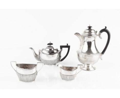 A MATCHED THREE PIECE SILVER BACHELOR'S TEA SERVICE, of half lobed form, the teapot with ebonised handle and knop, by John Hi