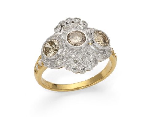 18k yellow and white gold ring adorned with 3 cognac diamonds weighting approximately 0.6 ct. and white diamonds weighting ap