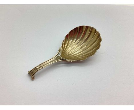 A Hallmarked Silver Caddy Spoon, (makers mark rubbed) possibly London 1830, with shell bowl and trifurcated scroll handle.
