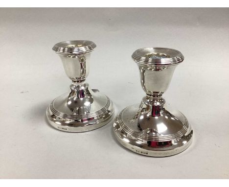 A Pair of Hallmarked Silver Dwarf Candlesticks, S&amp;M, Birmingham 1964, with reeded detail (bases weighted). (2)