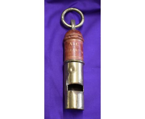 A vintage whistle without a date engraved at the top "If you need me whistle" and engraved on a leather background lower down