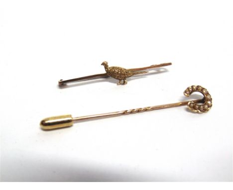 A SEED PEARL SET HORSESHOE STICK PIN stamped '15' and a pheasant bar brooch, stamped '9ct' (2)