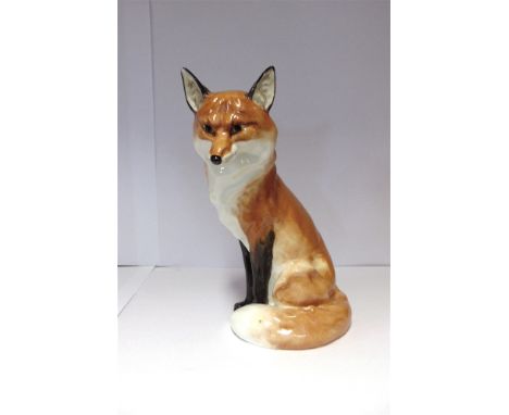 A ROYAL WORCESTER FIGURE OF A SEATED FOX  19cms high