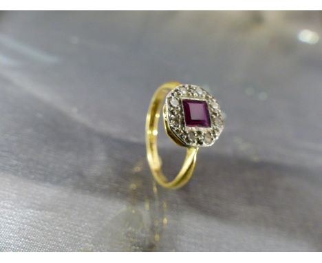 18ct Art Deco diamond and Ruby ring. The hexagonal platinum setting with central square cut bright Ruby and surround by eight