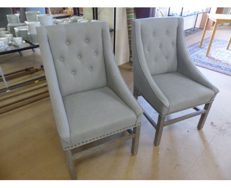 Two upholstered light grey contemporary armchairs 