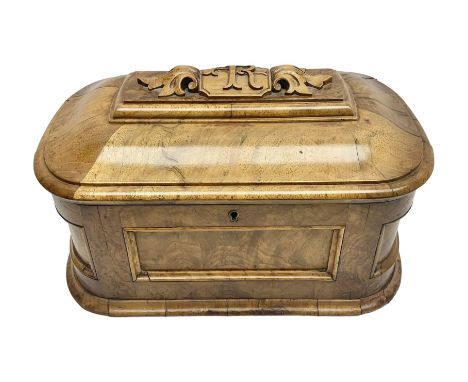 19th century figured walnut tea caddy, of rounded sarcophagus form, the hinged and slightly domed cover carved with monograme