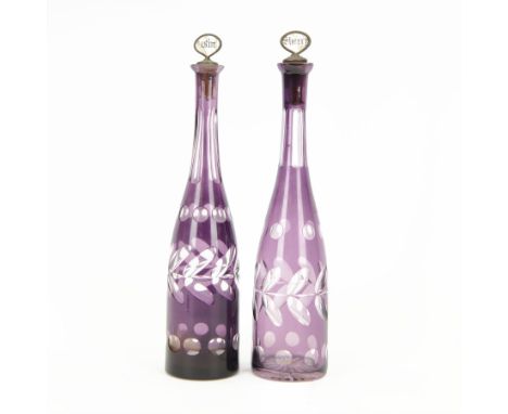 Two Victorian amethyst glass decanters, each of slender bottle form with decoration, both with contemporary mother of pearl l