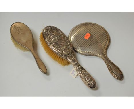 An engine turned silver backed hand mirror together with two silver backed hair brushes (3)