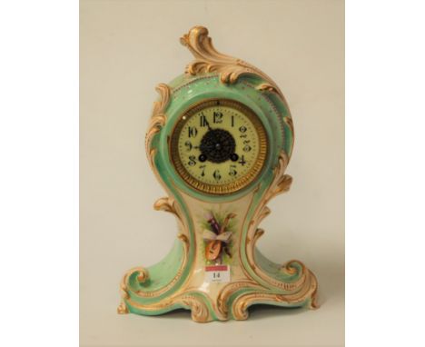 An early 20th century soft paste porcelain mantel clock in the Rococo taste, having French brass eight day cylinder movement 