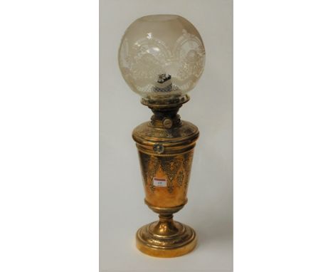 A late Victorian brass oil lamp having a spherical shade and No. 2 Hinks lever burner, the body with aesthetic movement influ