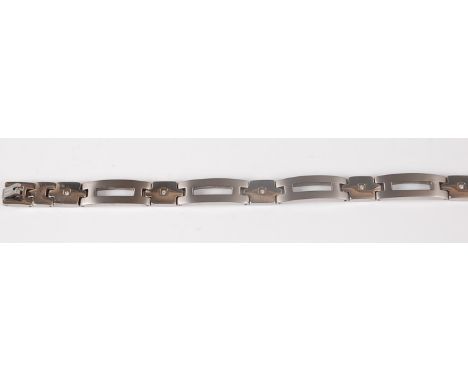 A modern titanium and diamond bracelet, the whole set with five diamond points, each weighing approx 0.02 carats, length 19cm