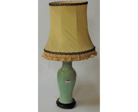 A Chinese celadon glazed vase of baluster form converted into table lamp, vase height 30cm. Vase has been drilled to the unde