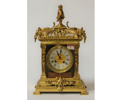 A brass mantel clock having applied cast decoration and 8-day cylinder movement striking on a gong, 20th century. Height 40cm
