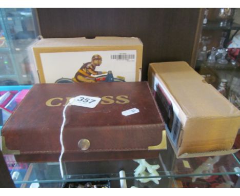 A modern tinplate motorcycle rider, a vintage bus (both boxed) and modern chess set