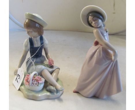 A Lladro figure girl in a pink dress and another girl seated with basket of flowers