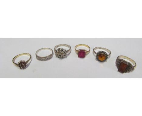 A 9ct gold garnet cluster ring, two silver and 9ct rings, 9ct ring and two other rings