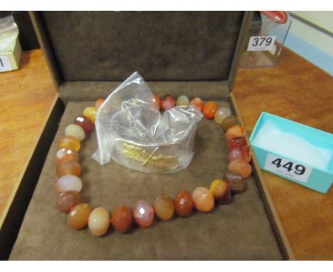 A bead necklace in mosaic box and a dragonfly bangle