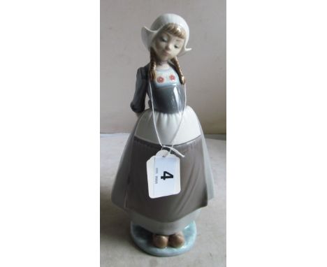 A Lladro figure Dutch girl being coy