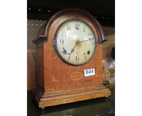 An Edwardian oak mantel clock