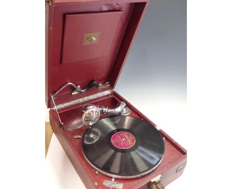 A VINTAGE HMV (HIS MASTERS VOICE) PORTABLE GRAMOPHONE IN RARE RED LETHERETTE COVERED OUTER.