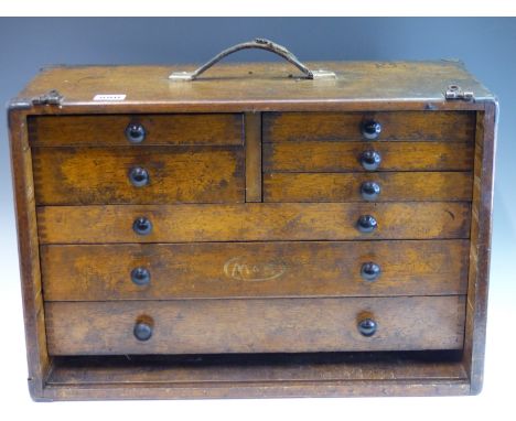 A VINTAGE WOODEN TOOL CHEST OF MULTIPLE DRAWERS, SOME CONTAINING MILLING AND OTHER TOOLS.