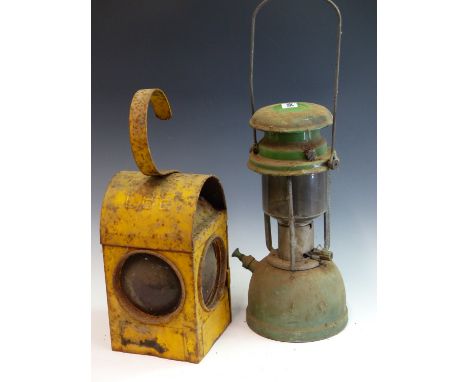 A VINTAGE TILLY LANTERN, 4 HURRICANE STORM LAMPS, A YELLOW PAINTED ROADWORKERS WARNING LIGHT AND ONE OTHER. the proceeds from