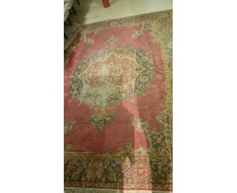 Large wool carpet with pink/red ground, some bare areas but overall a good attractive carpet 320 cm x 240 cm approx