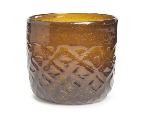 A Fatimid mould-blown glass beaker Egypt, 10th Centuryof amber glass and deep cylindrical form, a raised boss to the centre o