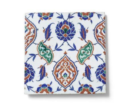 An Iznik pottery tile Turkey, circa 1575of square form, the white ground decorated in raised-red, cobalt blue, green and blac