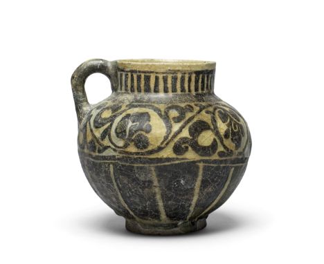 A Kashan silhouette ware pottery jug Persia, 12th/ 13th Centuryof globular form on a short foot, with cylindrical neck and ro