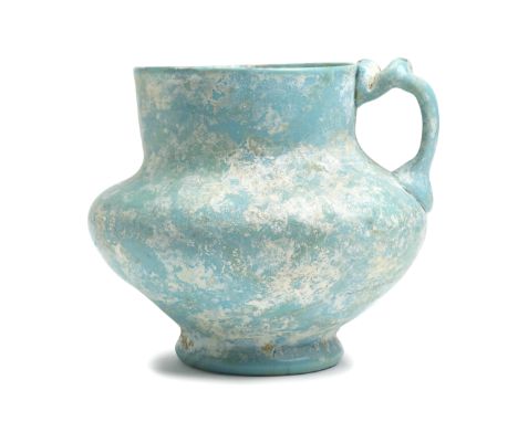 An opaque turquoise glass jug Persia or Egypt, 11th/ 12th Centuryof compressed globular form on short splayed foot with cylin