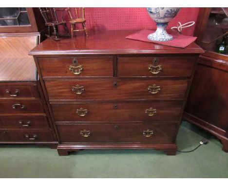 A George III mahogany chest of two short over three graduating long drawers on bracket feet