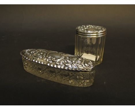 An oblong silver topped container, hallmarked Chester 1907/08, J & R Griffin a/f and a round topped container, Birmingham 190