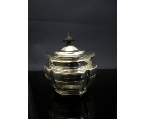 A William Aitken silver tea caddy, oval body with ribbed and fluted detail, ebonised knop, Chester 1901, 179g