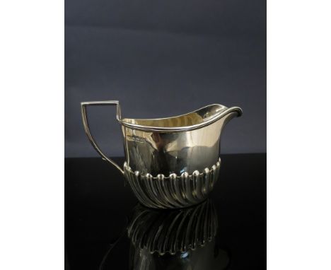 A Harrison Brothers and Howson silver cream jug, half wrythen fluted body, Sheffield 1898, 75g