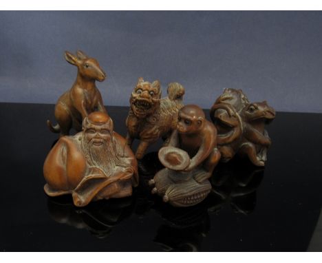 Five netsuke of sculptural form including three frogs, "See no evil, hear no evil, speck no evil"