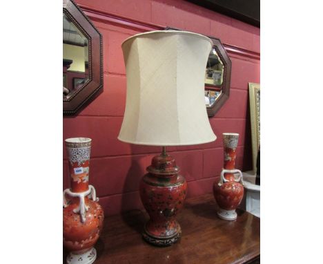 A twin light adjustable height table lamp, the burnt orange base decorated with birds in blossoming trees, gilt and black des