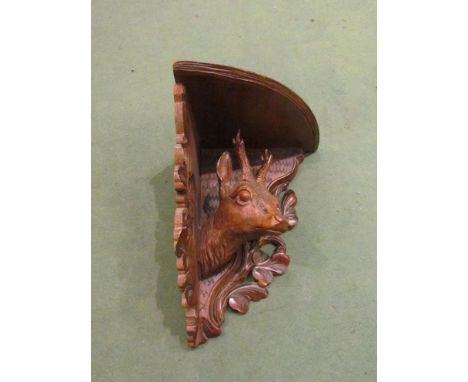 A Continental corner wall bracket with carved deer head design 
