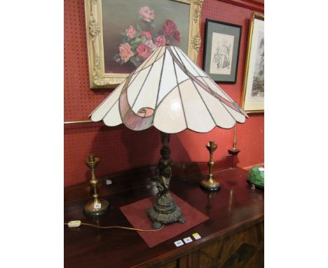 A figural table lamp with large leaded glass light shade