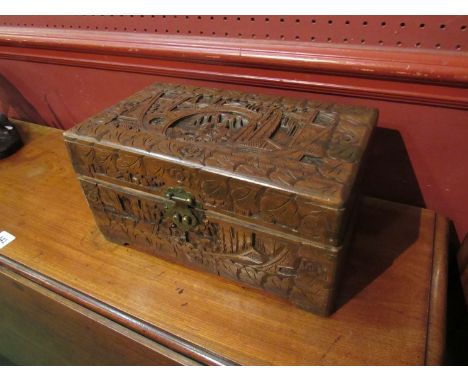 A carved wooden box decorated with Oriental figures 