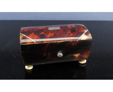 A 19th Century tortoiseshell trinket box with bun feet 
