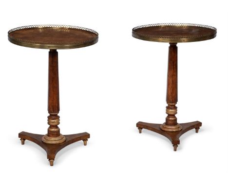 A PAIR OF GEORGE IV BURR ELM AND PARCEL GILT PEDESTAL OCCASIONAL TABLESIN THE MANNER OF GEORGE BULLOCK, CIRCA 1825The crossba