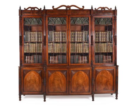 Y A GEORGE IV MAHOGANY AND SIMULATED ROSEWOOD BREAKFRONT LIBRARY BOOKCASE CIRCA 1825The lower moulded panel doors opening to 