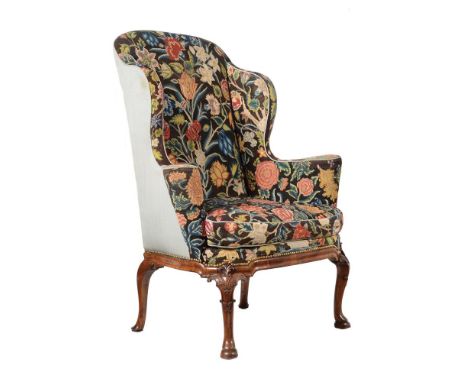 A GEORGE II WALNUT WING ARMCHAIR CIRCA 1730 Upholstered in floral needlework 122cm high, 94cm wide, 65cm deep overall Provena