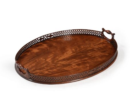 A GEORGE III MAHOGANY OVAL TRAY IN THE MANNER OF THOMAS CHIPPENDALE, CIRCA 1770With pierced gallery and side carrying handles