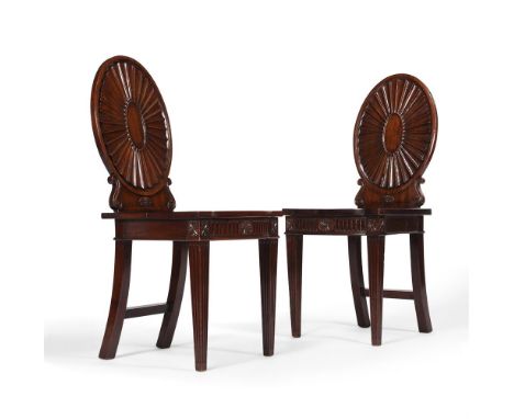 A PAIR OF GEORGE III MAHOGANY HALL CHAIRSIN THE MANNER OF MAYHEW & INCE, CIRCA 1780each 94cm high, 41cm wide, 45cm deep overa