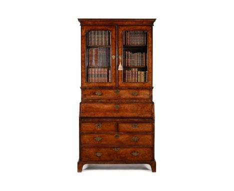 A GEORGE I WALNUT AND FEATHERBANDED SECRETAIRE BOOKCASE CIRCA 1725The fall front drawer opening to an arrangement of pigeon h